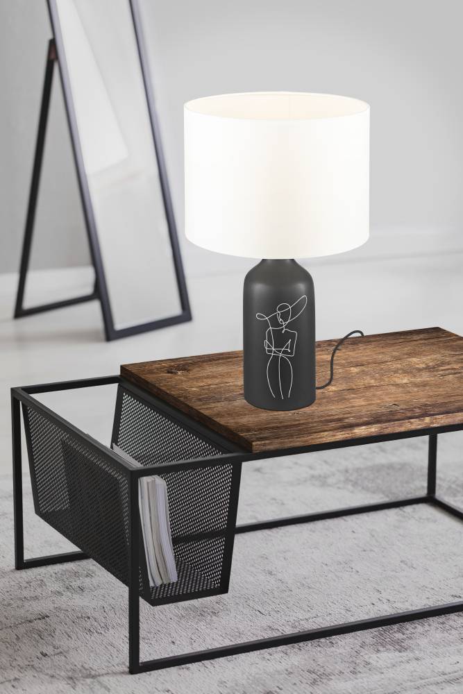 Vinoza 53cm Musta pöytävalaisin valmistajalta Eglo - Mustalla pohjalla, joka on koristeltu minimalistisilla linjoilla, jotka edustavat naista hatussa, valaisin lisää hienostuneen ja taiteellisen ilmeen kotiisi.
