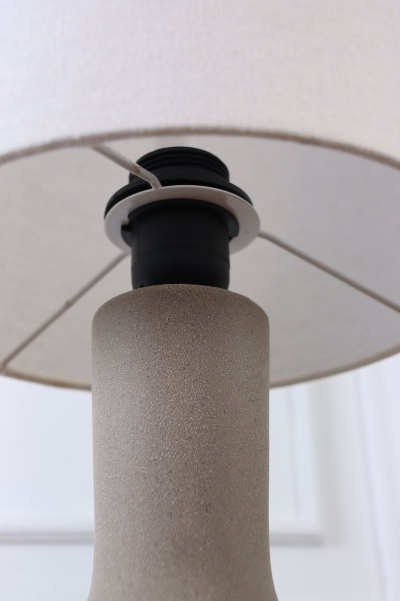 Lill Boda 52cm Hiekka pöytävalaisin valmistajalta Nordic Lighting - Kapea varsi kohtaa korkean, lieri&ouml;m&auml;isen, luonnonv&auml;risest&auml; pellavasta valmistetun varjostimen, joka levitt&auml;&auml; miellytt&auml;v&auml;&auml; ja tunnelmallista valoa huoneeseen.