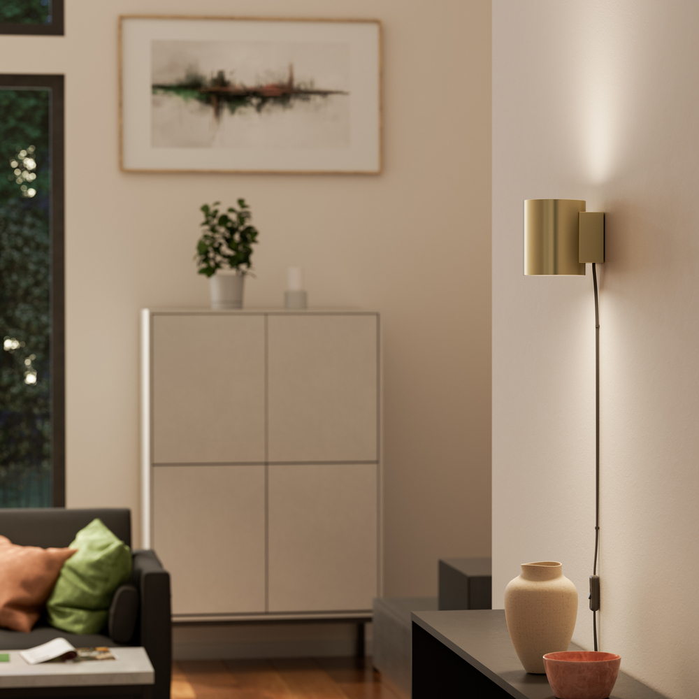 Evoke S Satiini messinki seinävalaisin valmistajalta Herstal - Den smarta konstruktionen med b&aring;de upp- och nerljus g&ouml;r den till ett utm&auml;rkt val f&ouml;r att belysa din hall, vardagsrum eller sovrum p&aring; ett subtilt men effektfullt s&auml;tt.